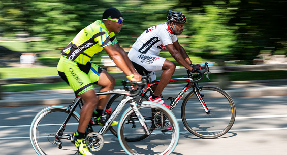 New York City, USA - 15 August 2018: Two african american men are training on their road racing bicycles in central park new york city.