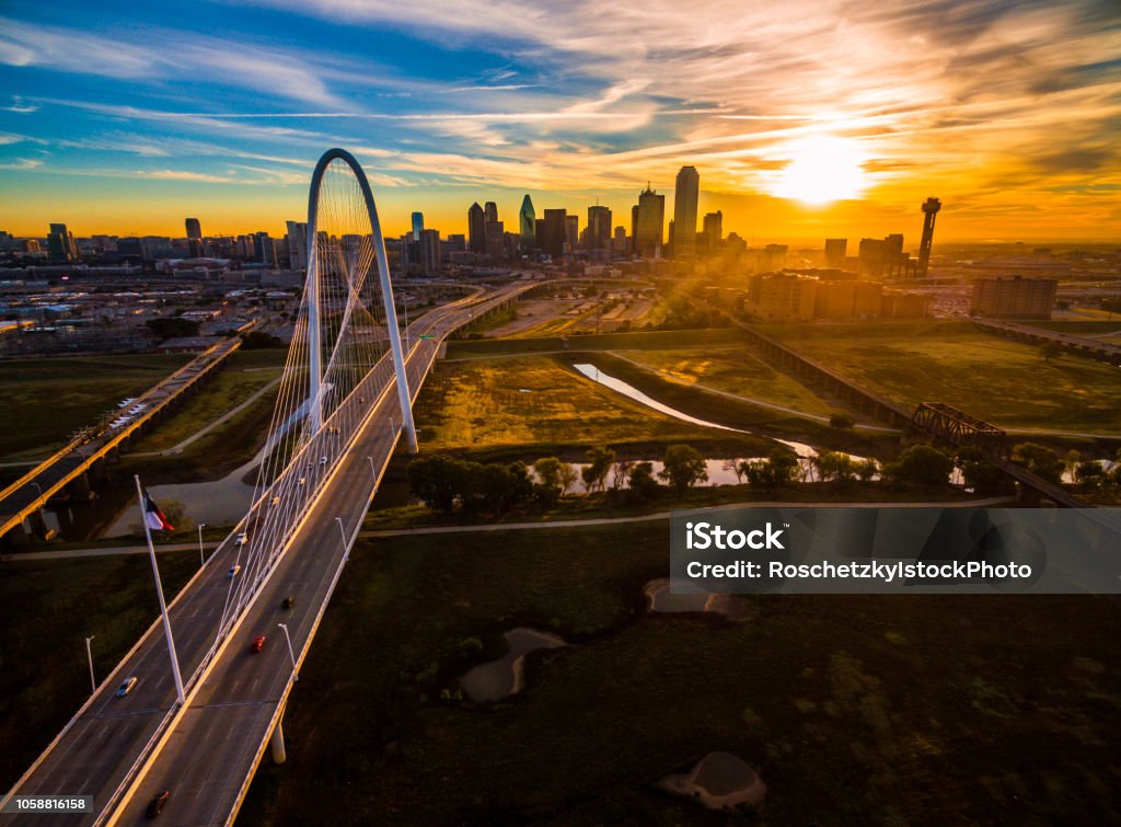 Dallas Texas Aerial drone view high above Dallas , Texas landscape at perfect golden hour with sun rays across entire landscape - skyline cityscape in background with large suspension bridge - Margaret Hunt Hill Bridge Dallas - Texas Stock Photo