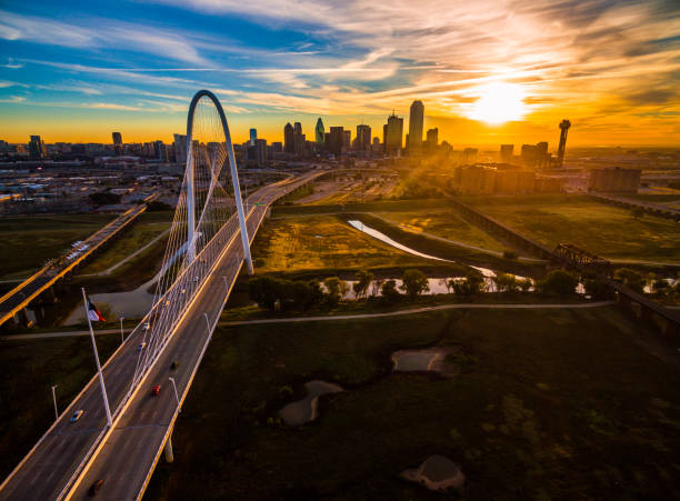 Dallas Texas Aerial drone view high above Dallas , Texas landscape at perfect golden hour with sun rays across entire landscape - skyline cityscape in background with large suspension bridge - Margaret Hunt Hill Bridge golden hour photos stock pictures, royalty-free photos & images