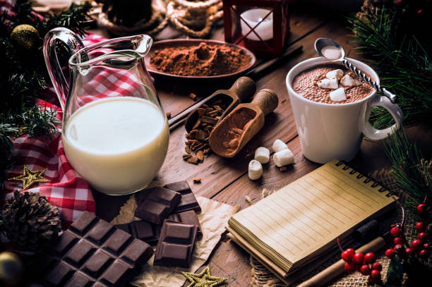 istock Christmas table setup with homemade chocolate mug with marshmallows and note pad 1058818440