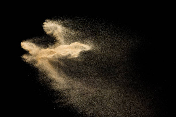 istock Golden sand explosion isolated on black background. Abstract sand cloud. 1058827360