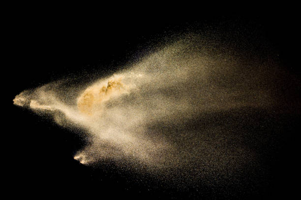 istock Golden sand explosion isolated on black background. Abstract sand cloud. 1058827926