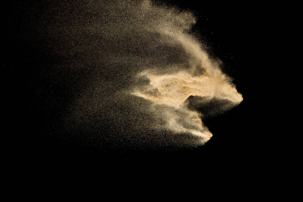 istock Golden sand explosion isolated on black background. Abstract sand cloud. 1058827952