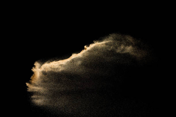 istock Golden sand explosion isolated on black background. Abstract sand cloud. 1058827962