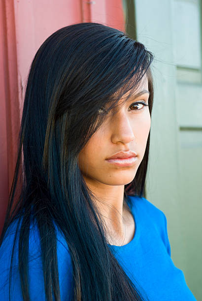 Young female staring down at camera stock photo