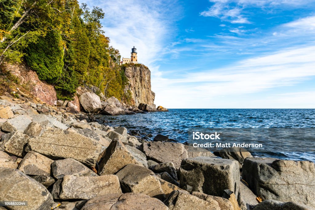 Split Rock Lighthouse Boulder Beach A boulder strewn beach leads to the cliff where Split Rock Lighthouse stands on the shores of Lake Superior in Northeastern Minnesota. Split Rock Lighthouse Stock Photo