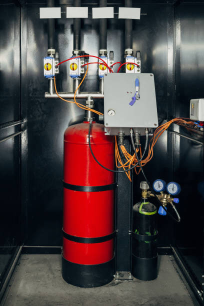 istock Black cabinet with modern industrial automatic fire extinguishing unit. Cylinders with fire extinguisher foam and nitrogen under pressure and automatic control system 1058833044