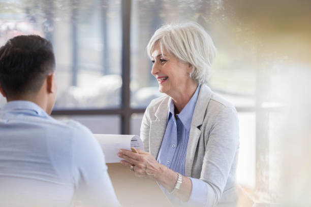 istock Senior female executive laughs at humor while holding a meeting 1058833046