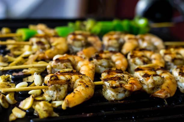 istock appetizing prawns seasoned fried with garlic on grill closeup background culinary design 1058833850
