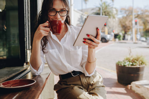 istock Businesswoman drinking coffee at cafe 1058835124