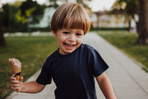 istock Happy boy with an ice cream outside 1058839676