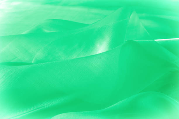 istock Texture, background, pattern. Green silk fabric for draping. Abstract Fabric, Artistic Waving Cloth Fractal Pattern 1058840388