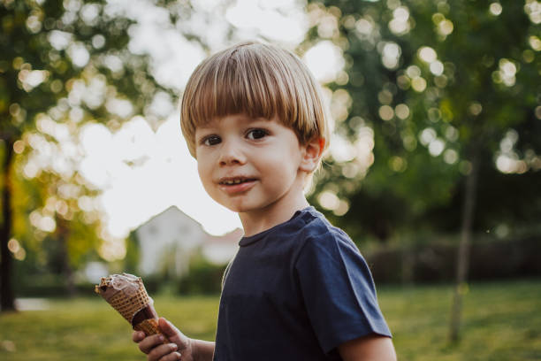 istock Happy boy with an ice cream outside 1058840392