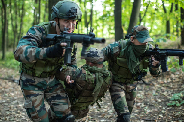 istock Soldiers helping out to wounded friend 1058840740