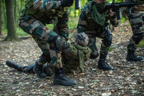 istock Soldiers helping out to wounded friend 1058840798