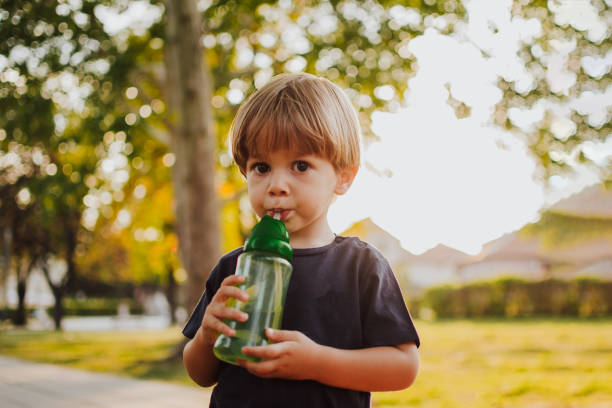istock Happy boy with an ice cream outside 1058841182