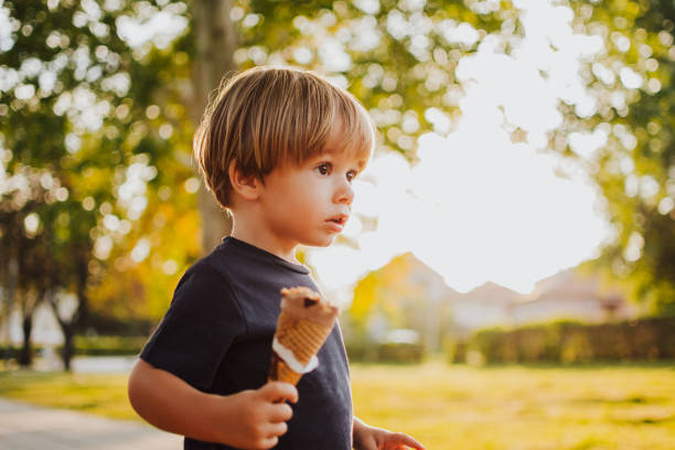 istock Happy boy with an ice cream outside 1058842608