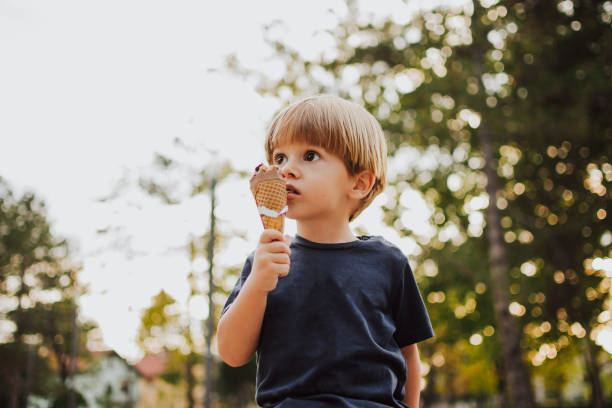 istock Happy boy with an ice cream outside 1058842698