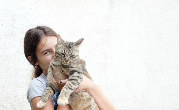 istock Girl holding her friendly cat 1058844102