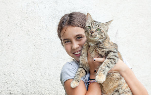 istock Girl holding her friendly cat 1058844104