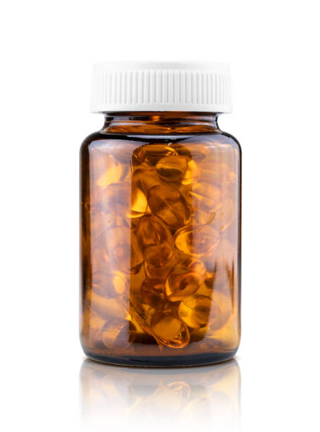 魚の油は茶色のガラス瓶の中の栄養補助食品カプセル - nutritional supplement fish oil vitamin pill bottle ストックフォトと画像