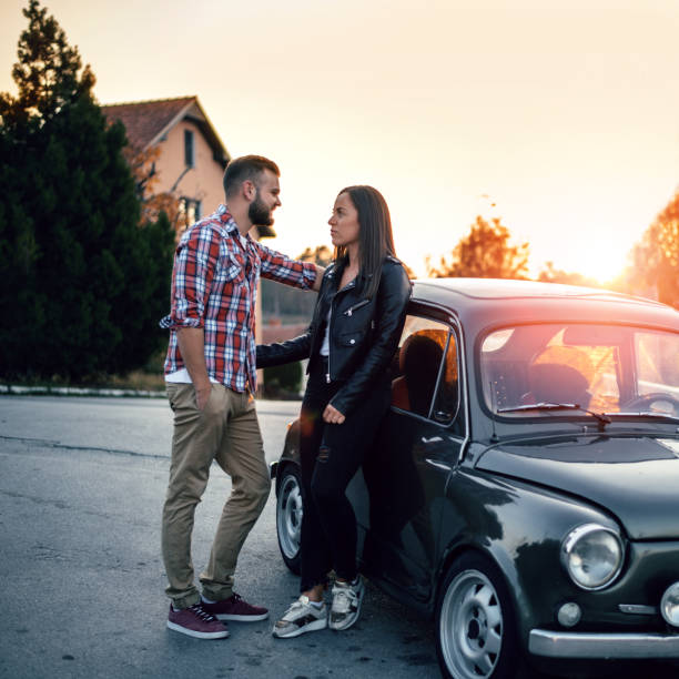 istock Couple hugging by car at sunset 1058845720