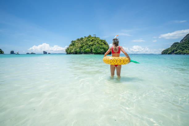istock Snorkelling girl in Thailand with inflatable pineapple 1058852418
