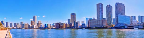 istock Wide angle vibrant panoramic view of winter Sumida river under blue sky in Tokyo 1058852538