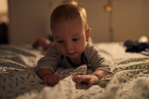 istock 4 months old baby laying on bed 1058854536