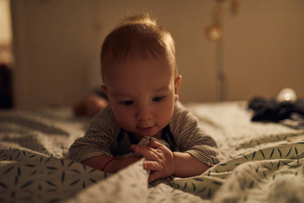 istock 4 months old baby laying on bed 1058854580