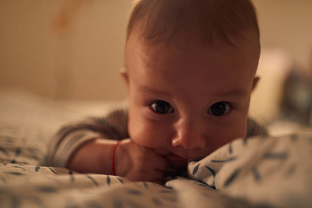 istock 4 months old baby laying on bed 1058855078