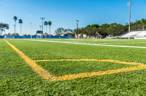 Football green grass field with corner yellow lines