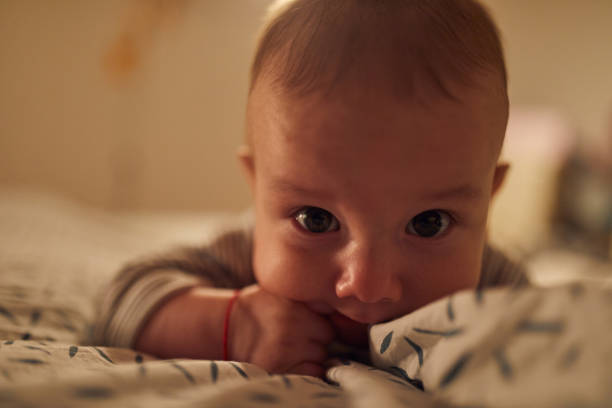 istock 4 months old baby laying on bed 1058856164