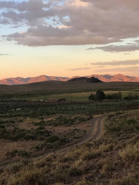 istock Sunset On A Rural Dirt Road 1058856174
