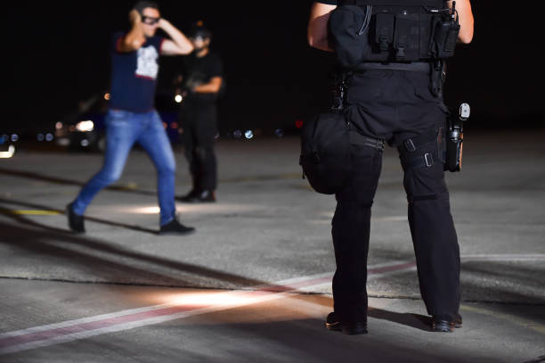 istock Night scene with special forces showing their skills in a simulated hostage rescue drill 1058857072