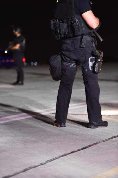 istock Night scene with special forces showing their skills in a simulated hostage rescue drill 1058857082