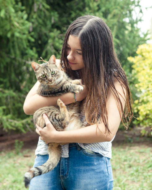 istock Young woman holding her friendly cat 1058859322