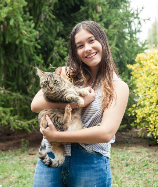 istock Young woman holding her friendly cat 1058859324