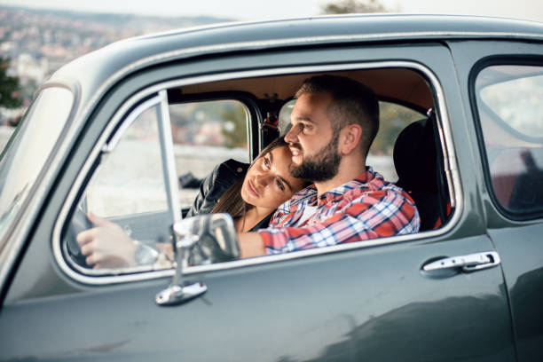 istock Couple watching the sunset in a car. 1058859686