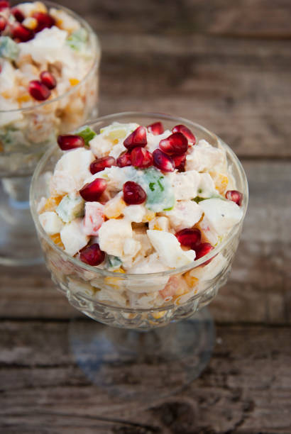 istock Traditional russian salad with mayonnaise on wooden table. Rustic background. 1058861958