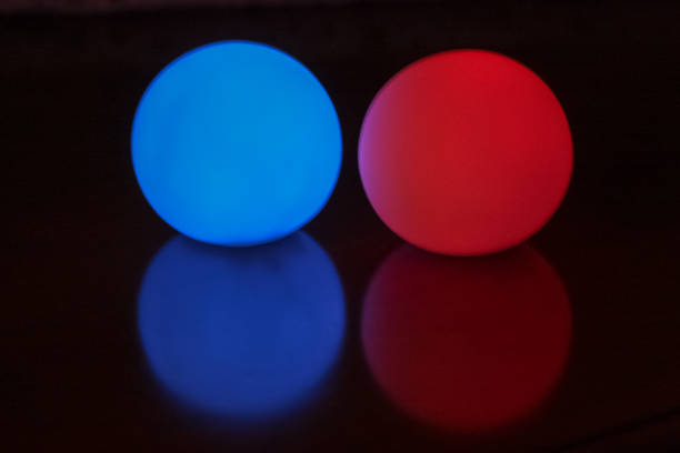 istock backgrounds with colored lighted balls and reflection on black ground 1058865228