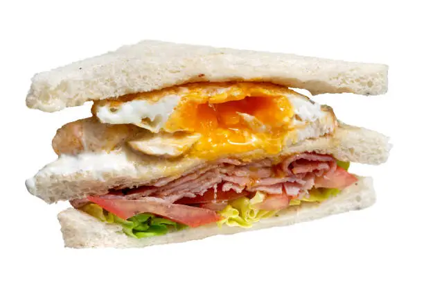 Bacon and egg club sandwich isolated on white.