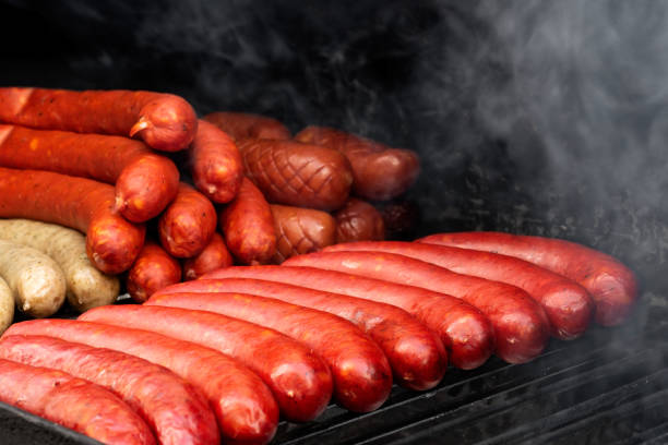 istock Bratwurst sausages on smoky cast iron griddle. 1058867560