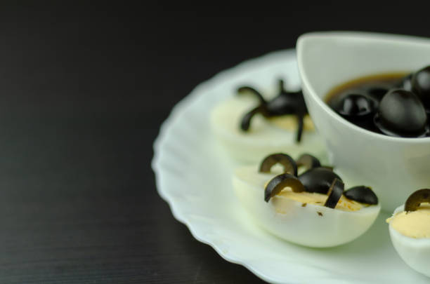 istock funny snack with olive spiders on egg halves for halloween party, 1058868132
