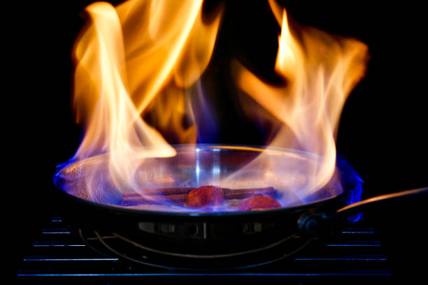 Chef Cooking with Fire Flame  in frying iron pan