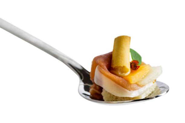 istock Spoon canape with parma ham isolated on white. 1058868652
