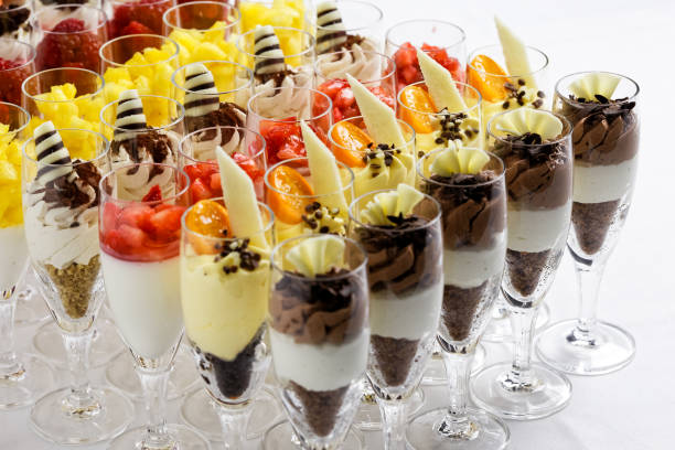istock Mixed chocolate and fruit desserts in glass flutes on white. 1058868758