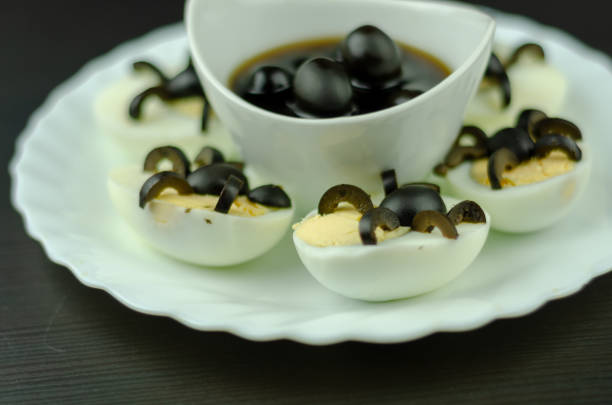 istock funny snack with olive spiders on egg halves for halloween party, 1058872442