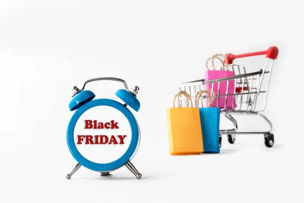 online shopping / e-commerce sale and delivery service concept, discounts, black Friday, sale: shopping cart multicolored packages and boxes with trolleybus logo on white background,