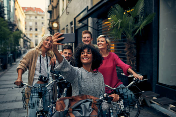 istock Friends Riding Bicycles In A City 1058880052